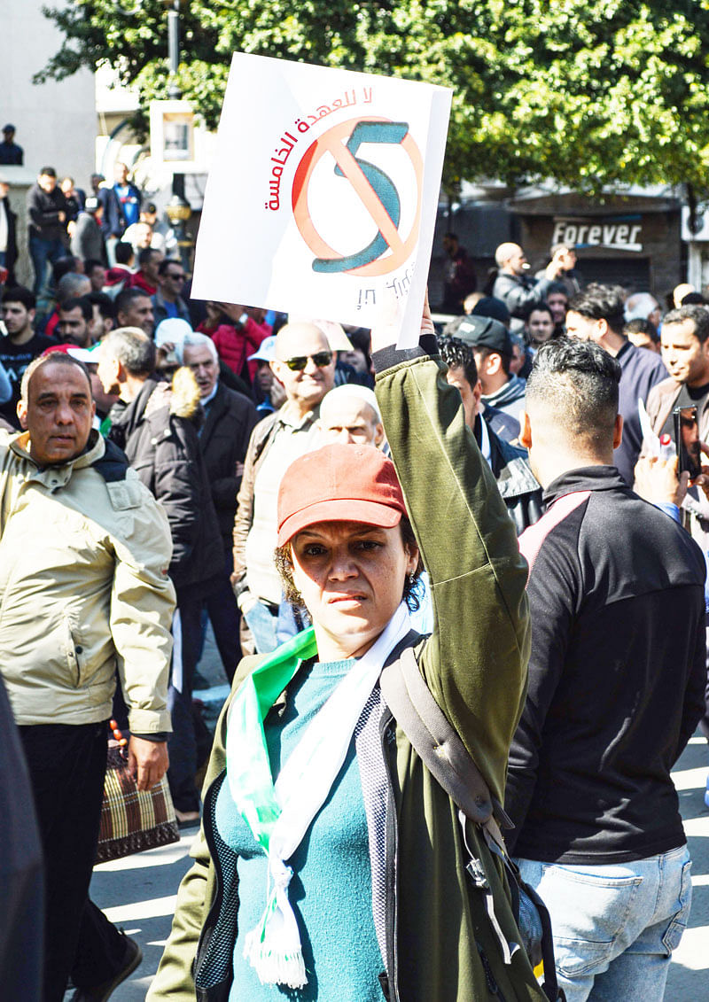 An Algerian woman marches with a sign during a protest rally against ailing President Abdelaziz Bouteflika`s bid for a fifth term in power, in the northeastern city of Annaba, about 570 kilometres west of the capital Algiers and about 100 kilometres east of the border with Tunisia, on 1 March 2019. Photo: AFP