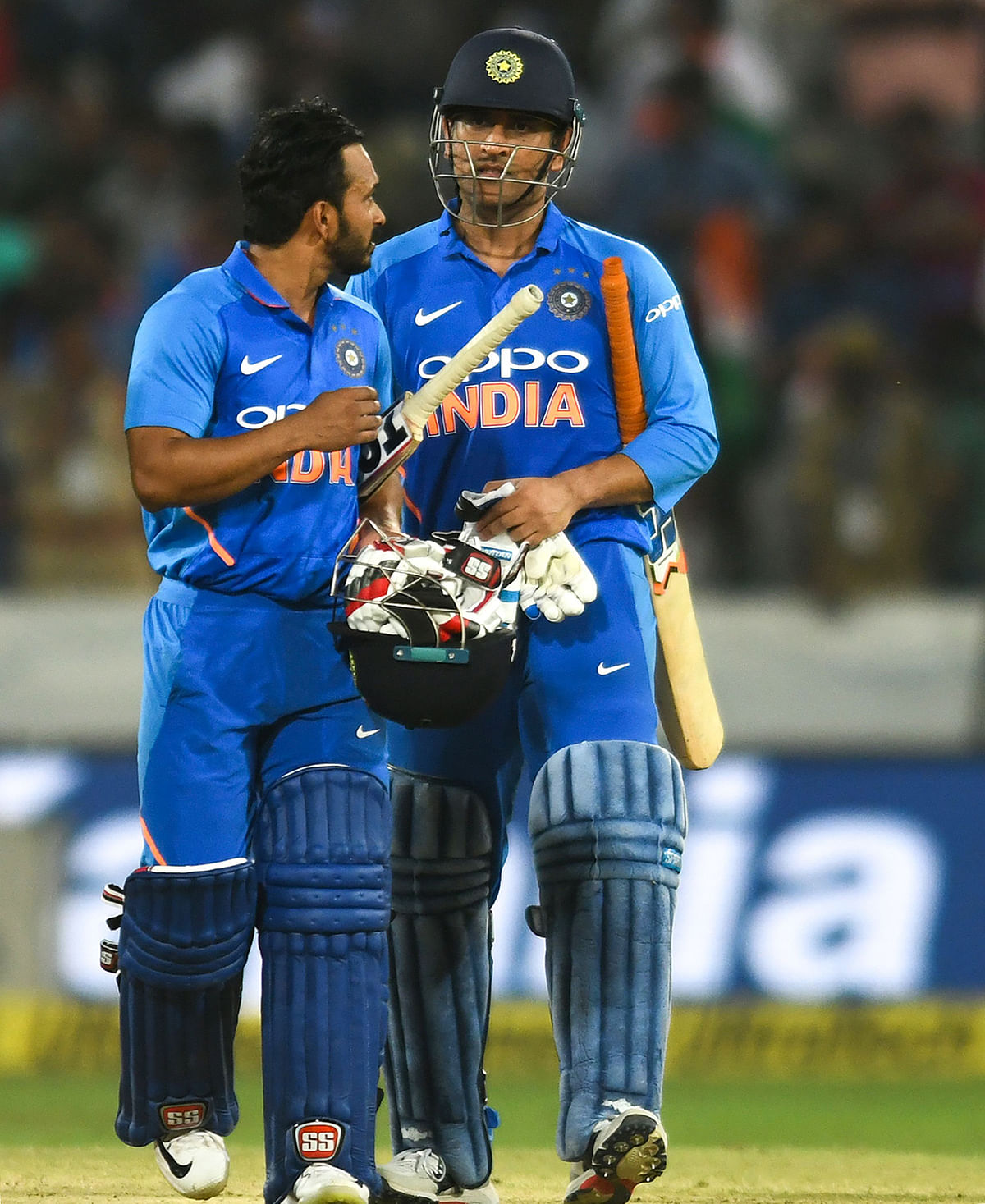 Indian cricketer Mahendra Singh Dhoni (R) and Kedar Jadhav (L) react as they walk out of the field after winning the first one day international (ODI) cricket match between India and Australia at the Rajiv Gandhi International Cricket Stadium in Hyderabad on 2 March, 2019. Photo; AFP