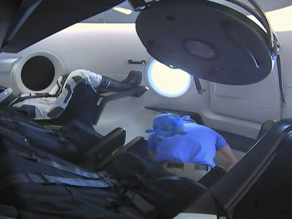 This video grab taken from NASA TV on 3 March 2019, shows a dummy(L) named Ripley onboard a SpaceX Falcon 9 rocket with the company`s Crew Dragon spacecraft onboard after the opening of the hatch during the Demo-1 mission. Photo: AFP