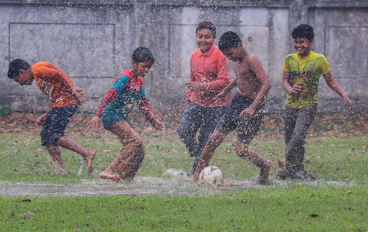 Children playing in a puddle at Mujgunni play ground in Khulna on 8 March. Photo: Saddam Hussain