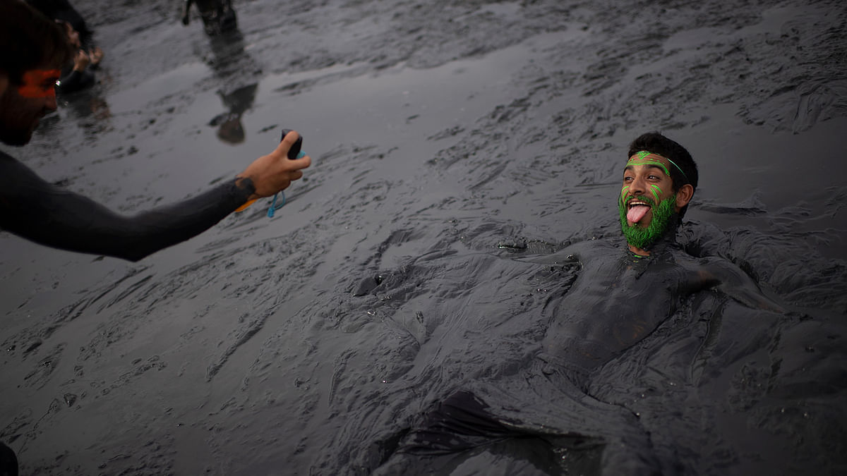 A reveller poses for a picture as he takes part in the `Bloco da Lama`, a mud carnival party, in Paraty, Rio de Janeiro state, Brazil, on 2 March 2019. Photo: AFP