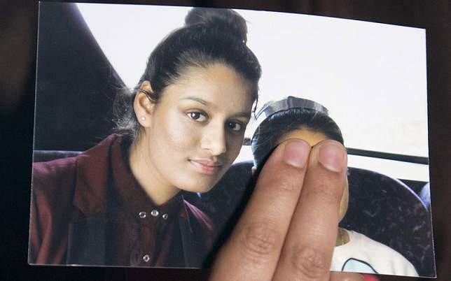 In this file photo taken on 22 February 2015 Renu Begum, eldest sister of missing British girl Shamima Begum, holds a picture of her sister while being interviewed by the media in central London. AFP File Photo