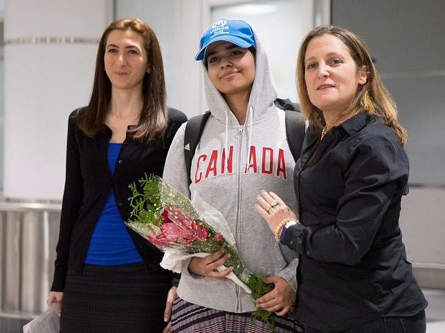 This AFP file photo shows another Saudi girl Rahaf Mohammed Alqunun, 18, center, stands with Canadian Minister of Foreign Affairs Chrystia Freeland, right, as she arrives at Toronto Pearson International Airport, on Saturday, 12 January 2019 after fleeing her home.