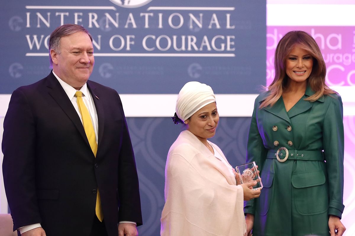 Razia Sultana of Bangladesh (C) is given the International Women of Courage Award by US secretary of state Mike Pompeo and US first lady Melania Trump during a ceremony in the Dean Acheson Auditorium at the Department of State`s Harry S Truman building 7 March, 2019 in Washington, DC. Photo: AFP