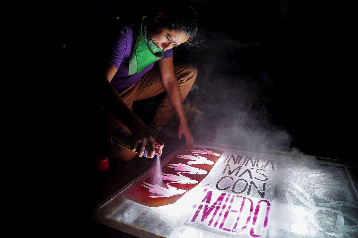 A demonstrator spray paints stencils on Constitution Square during a march on International Women`s Day in Mexico City, Mexico, 8 March 2019. Photo: Reuters