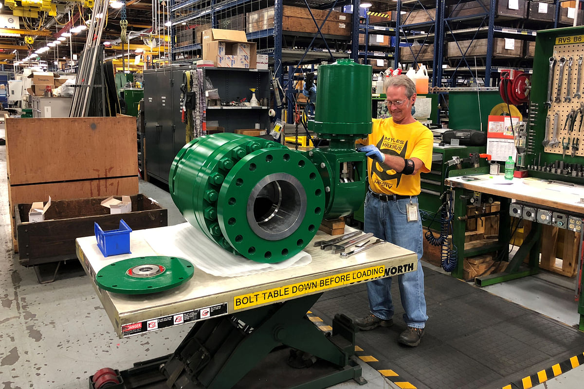 A worker assembles an industrial valve at Emerson Electric Co.’s factory in Marshalltown, Iowa, US, 26 July 2018. Photo: AFP