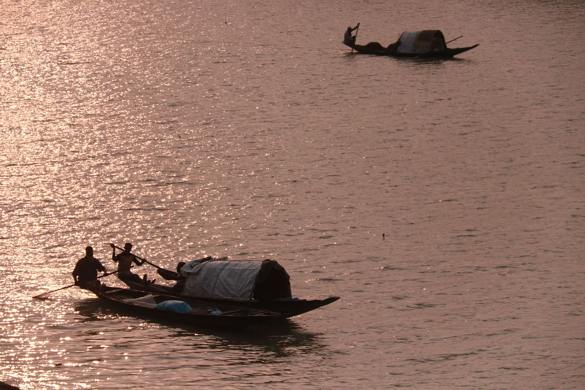 Men returning with fish collected on boats during sunset at Chengerkhal in Sylhet on 9 March. Photo: Anis Mahmud
