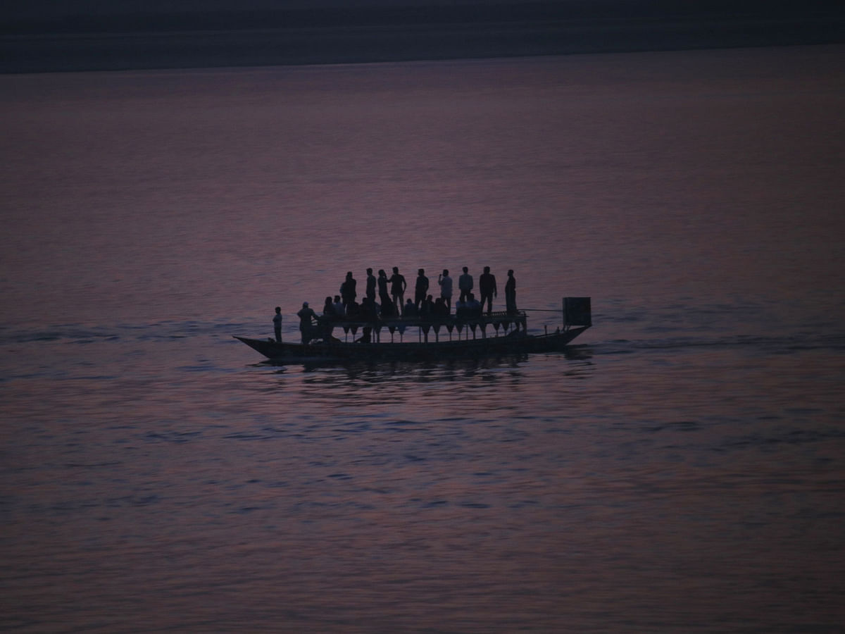 People returning home by boat across the river Jamuna at Tangail on 9 March. Photo: Mosabber Hossain