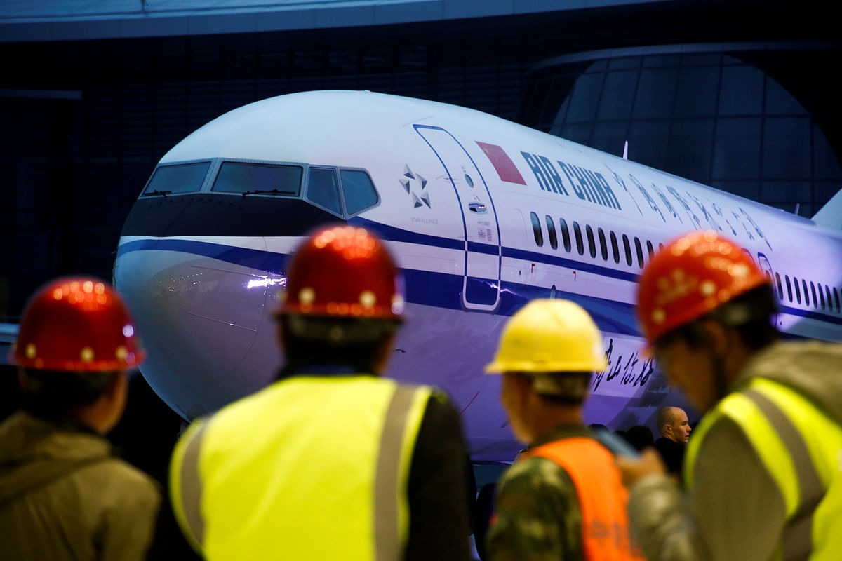 Workers attend a ceremony marking the 1st delivery of a Boeing 737 Max 8 airplane to Air China at the Boeing Zhoushan completion center in Zhoushan, Zhejiang province, China, 15 December 2018. Photo: Reuters