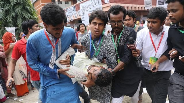 Fellow students carrying Nur after he was allegedly attacked by BCL activists during the DUCSU polls at Dhaka University on 11 March. Photo: Dipu Malakar