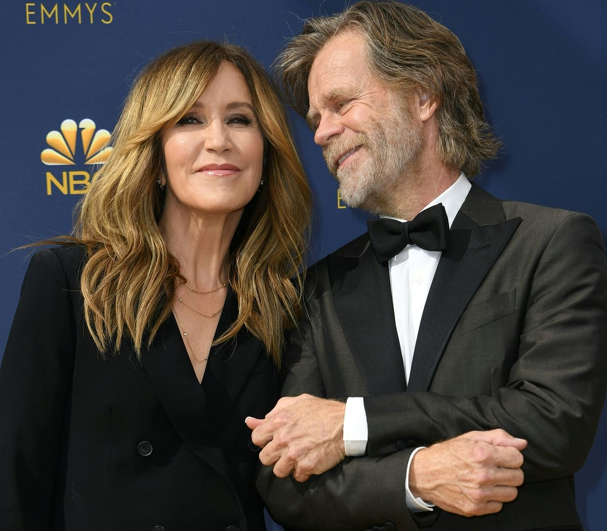 In this file photo taken on 17 September 2018 Lead actor in a comedy series nominee William H. Macy and his wife actress Felicity Huffman arrive for the 70th Emmy Awards at the Microsoft Theatre in Los Angeles.