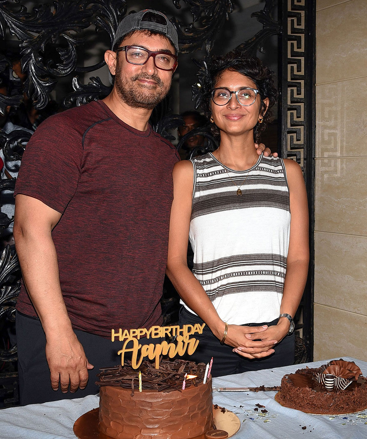 Indian Bollywood actor and producer Aamir Khan (L) along with his wife, film director and screenwriter Kiran Rao Khan (R), pose for photographs on his 54th birthday at his residence in Mumbai on 14 March, 2019. Photo: AFP