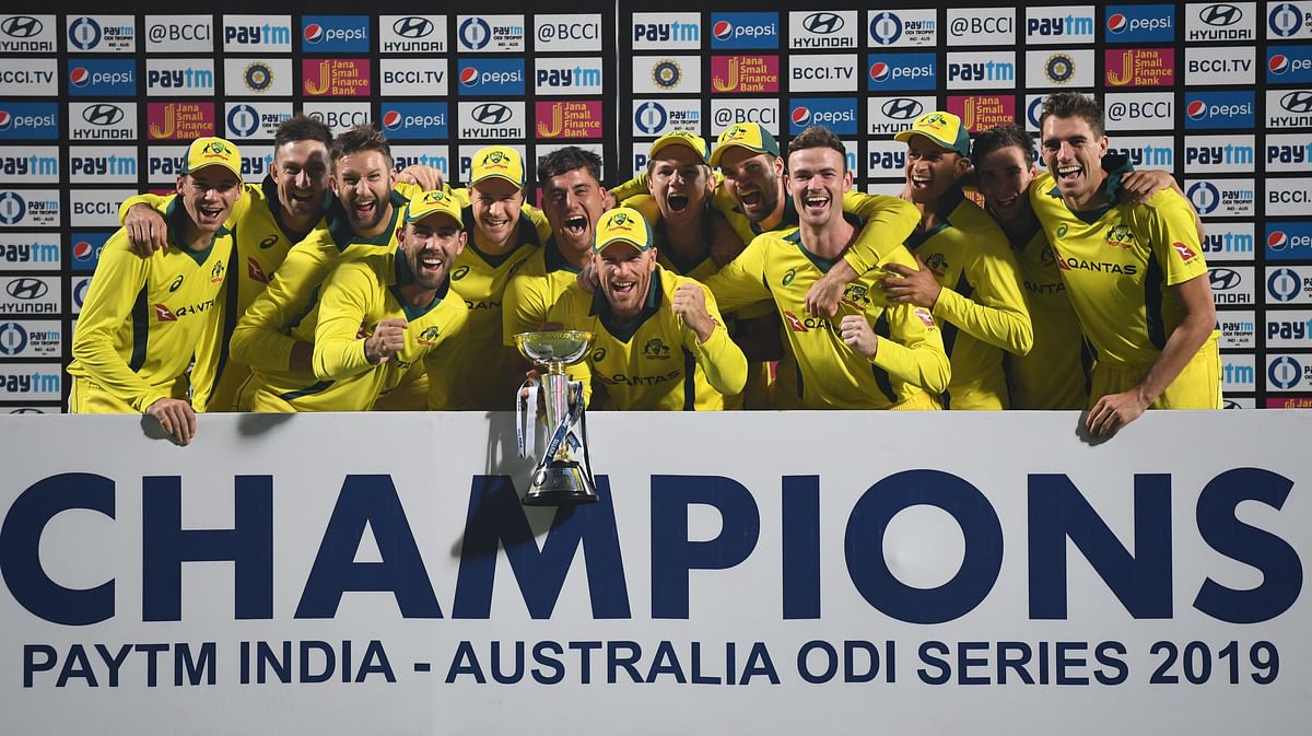 Australian cricketers poses with the winning trophy after winning the fifth one-day international (ODI) cricket match between India and Australia at the Feroz Shah Kotla Stadium in New Delhi on 13 March 2019. Photo: AFP