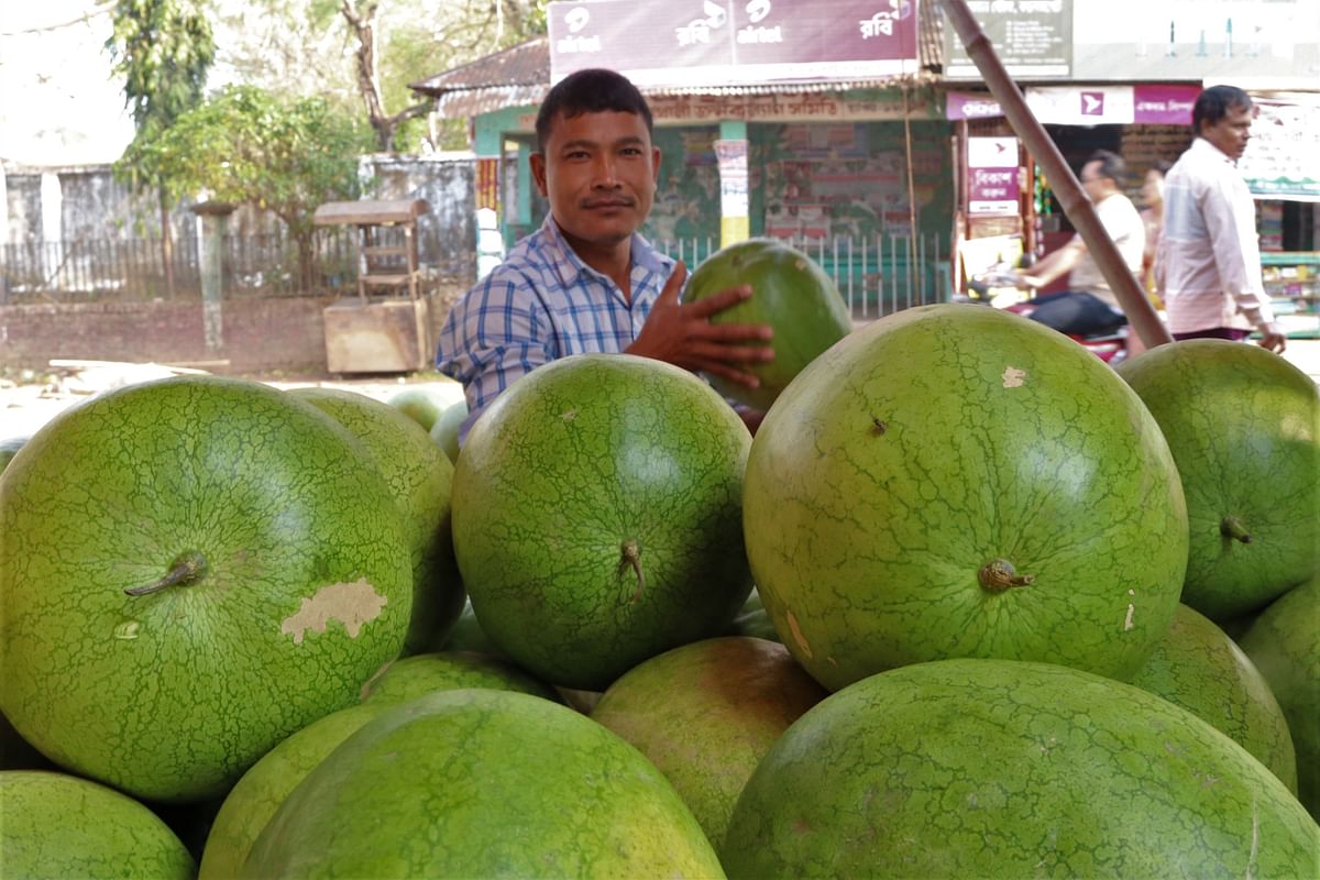 Wholesalers sell melons by the roadside at College Gate of Rangamati on March 14. Photo: Supriya Chakma