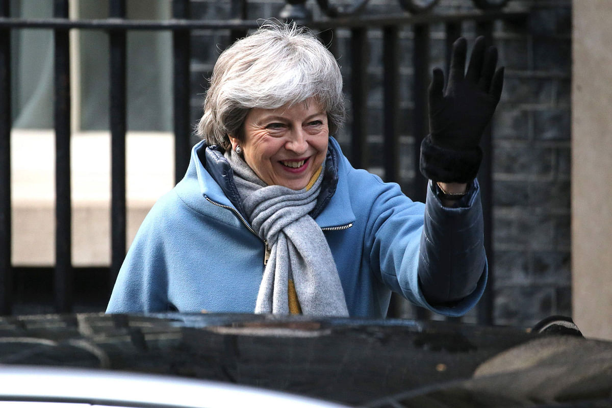 Britain`s prime minister Theresa May waves as she leaves 10 Downing Street in London on 14 March ahead of a further Brexit vote. Photo: AFP