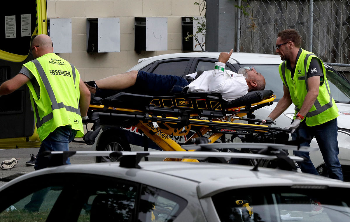 Police and ambulance staff help a wounded man from outside a mosque in central Christchurch, New Zealand, on 15 March 2019. Photo: AP