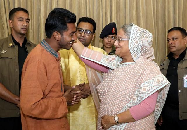 PM Hasina greets newly-elected DUCSU VP Nurul Haq Nur touching his head at her official residence Ganabhaban on Saturday. Photo: PMO