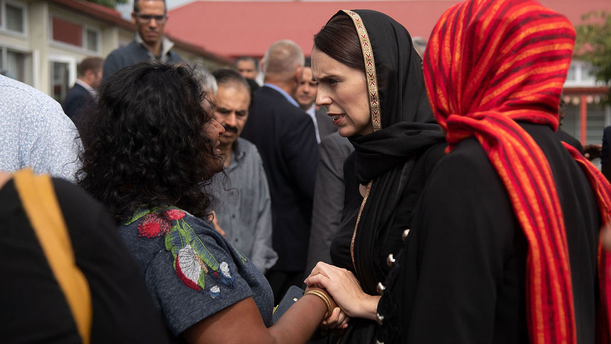 New Zealand prime minister Jacinda Ardern (C) speaks with a representative of the refugee centre during a visit to the Canterbury Refugee Centre in Christchurch on 16 March 2019. Photo: AFP