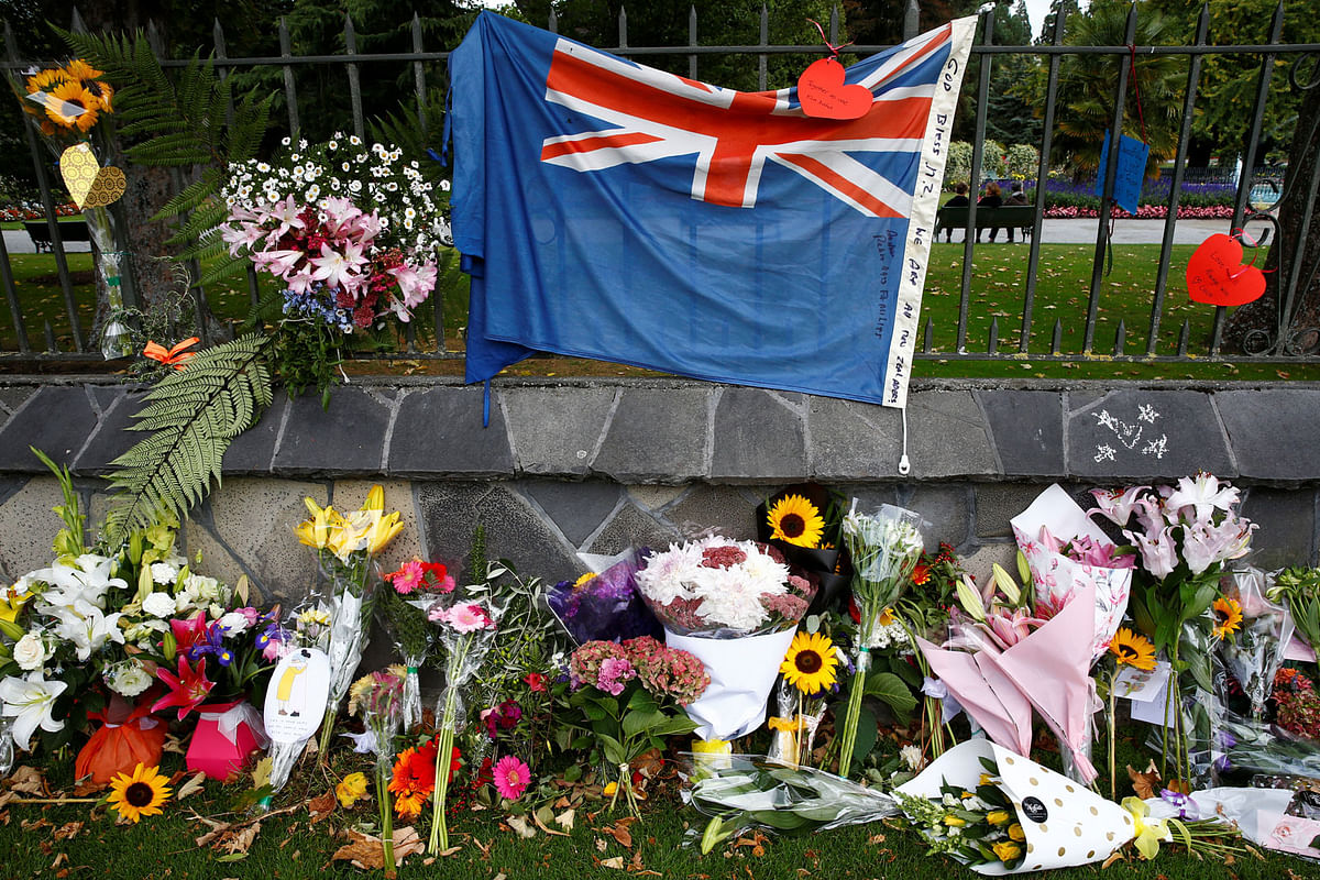 Flowers and a New Zealand national flag are seen at a memorial as tributes to victims of the mosque attacks near Linwood mosque in Christchurch, New Zealand, on 16 March 2019. Photo: Reuters
