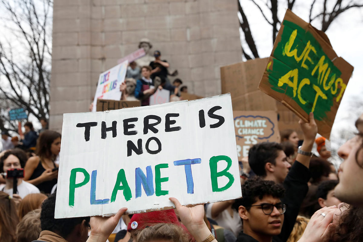 Students hold placards during a demonstration against climate change at Columbus Circle in New York, US on 15 March. Photo: Reuters