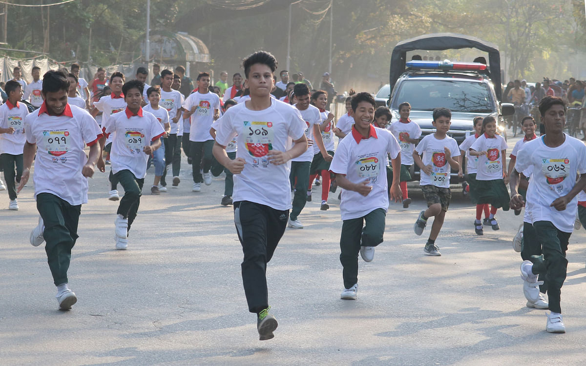 Children taking part in a mini marathon  at Dhaka University premises arranged by Bangladesh Shishu Academy and Everest Academy to mark the 99th birth anniversary of Bangabandhu Sheikh Mujibur Rahman and the national children`s day on 16 March. Photo: Paul Joy