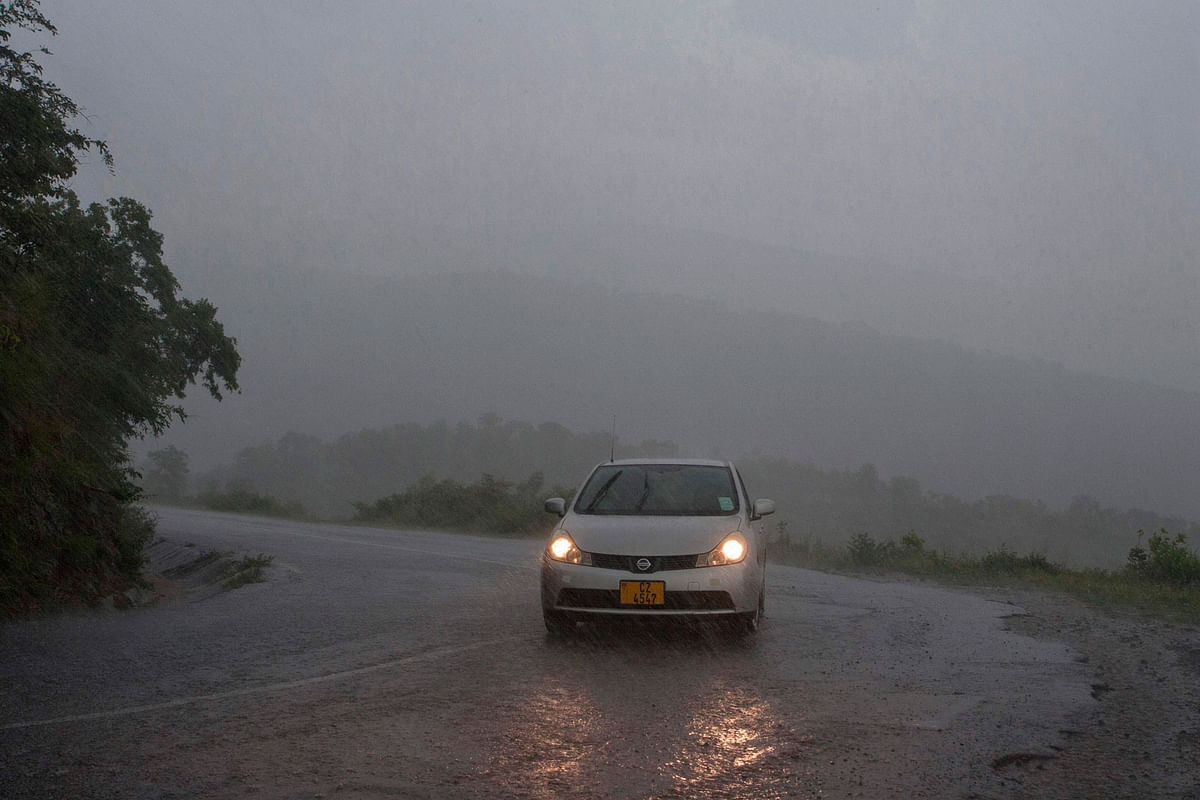 his picture taken on 15 March 2019 shows a vehicule as rain, which is believed to be the beginning of Tropical cyclone Idai coming from central Mozambique, falls in the flooded districts of Chikwawaa and Nsanje in southern Malawi. At least 56 people have died in flood-hit areas as of 13 March according to the government, while 577 had been injured and almost 83,000 people have been displaced. Photo: AFP
