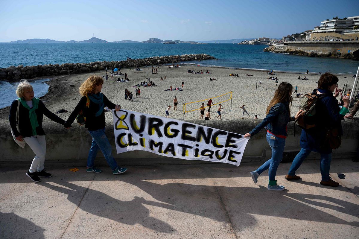 Demonstrators hold a placard reading `climate emergency` as hundreds of people take part in a `March of the Century` in Marseille, on 17 March 2019, aiming to push world leaders into action on climate change. Photo: AFP