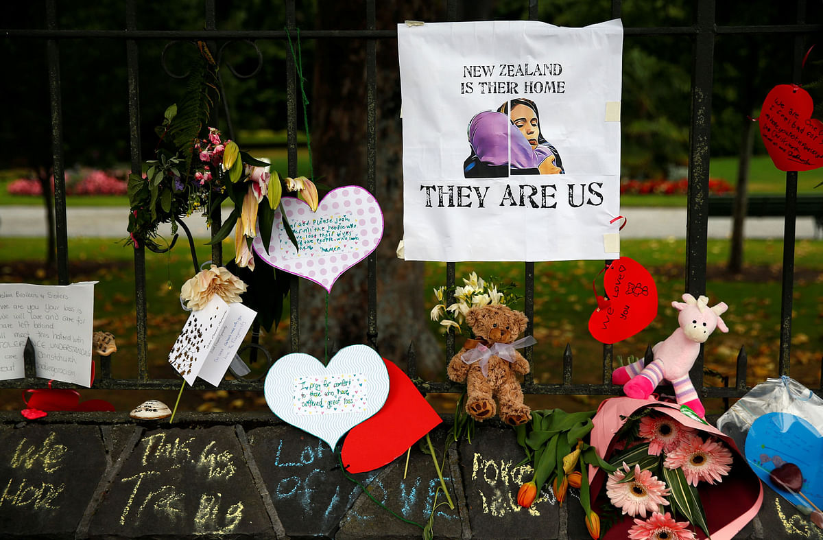 Flowers and signs are seen at a memorial site for victims of the mosque shootings, at the Botanic Gardens in Christchurch, New Zealand on 18 March.Photo: Reuters