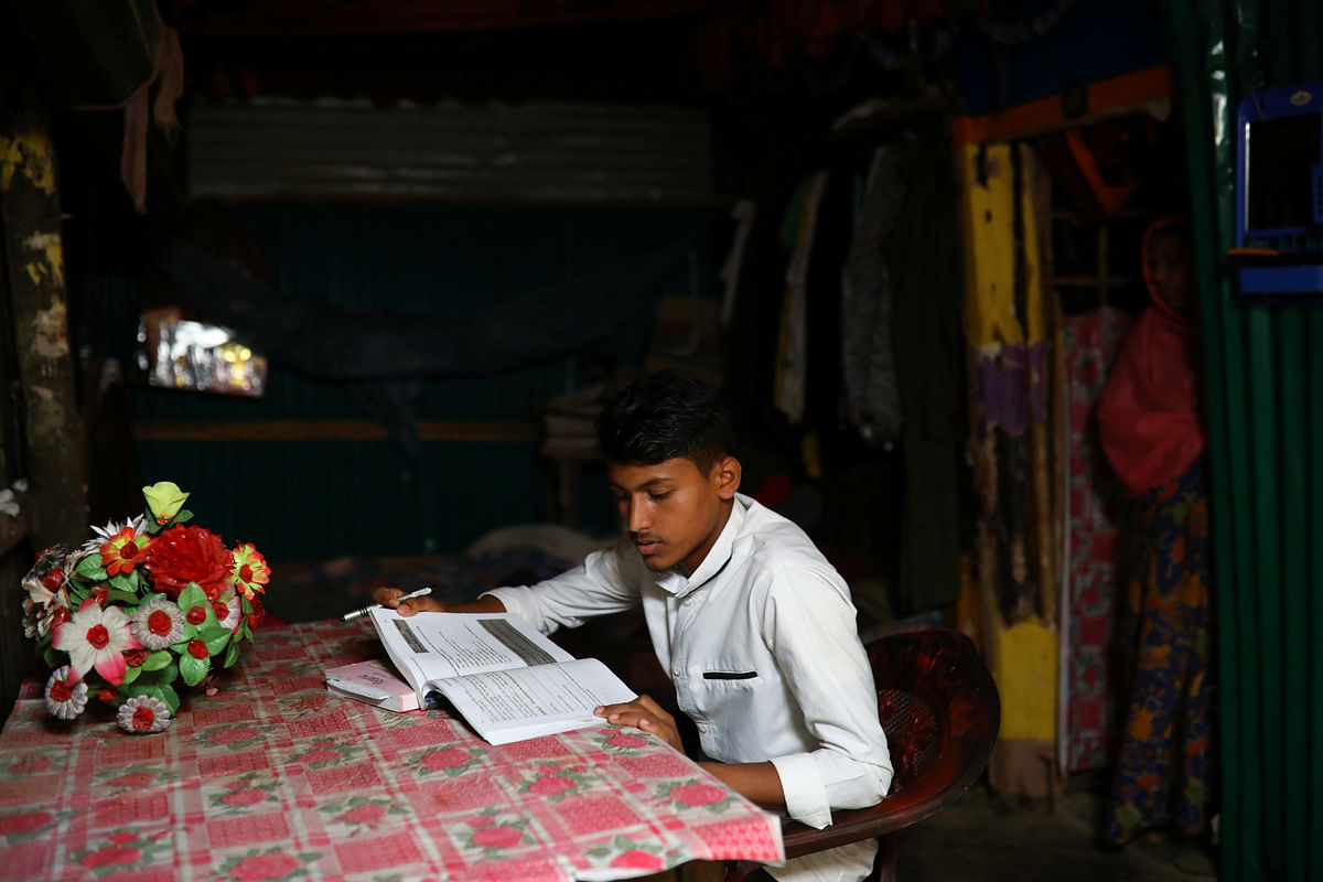 Kefayat Ullah, a Rohingya boy who was expelled from Leda High School for being a Rohingya, studies in his shelter in Leda camp in Teknaf, Bangladesh, 5 March, 2019. Photo: Reuters