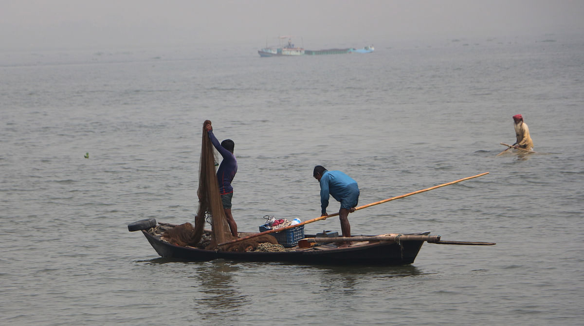 Two men busy catching fish at river Meghna at Shaatnol, Chandpur on 19 March 2019. Photo: Dinar Mahmud
