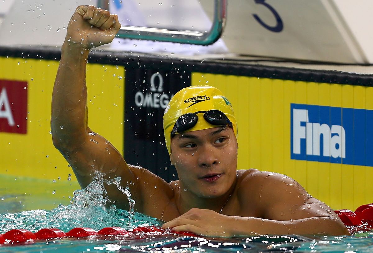 In this file photo taken on 18 October 2013 Kenneth To of Australia celebrates after winning the men`s 100m Breaststroke race on the second and last day of the fourth stage of the 2013 FINA Swimming World Cup in Dubai. Record-breaking Hong Kong and Australia swimmer Kenneth To has died suddenly aged 26 after falling unwell at a Florida training camp, officials said on 19 March 2019. Photo: AFP