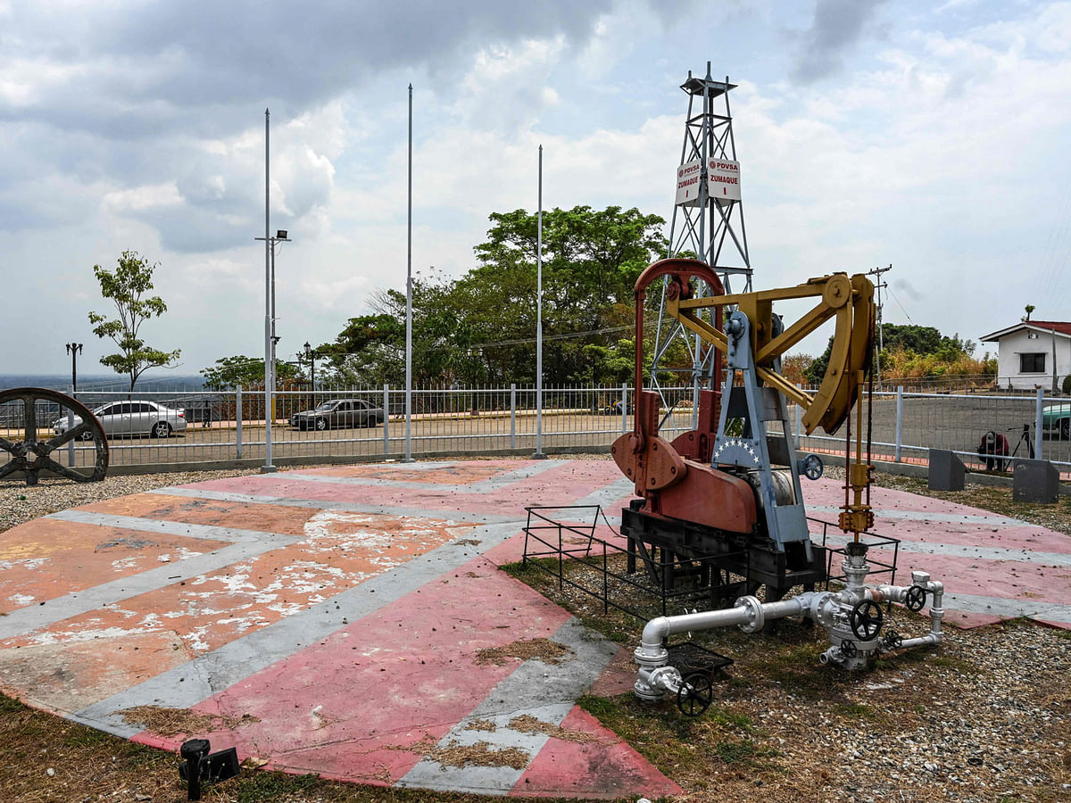This file photo taken on 15 March 2019 shows a view of the `Zumaque I` pumpjack with which production was started in 1914 in Mene Grande, Zulia state, Venezuela. The modest Venezuelan town where the country`s oil exploration began, attracting thousands during its boom more than a century ago, now remains impoverished and desolated, and the oil workers who used to `live like kings` now struggle to survive. Photo: AFP