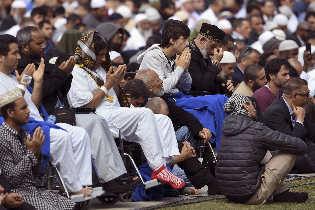 Injured people from the shootings pray during congregational Friday prayers and two minutes of silence for victims of the twin mosque massacre, at Hagley Park in Christchurch on 22 March 2109. Photo: AFP