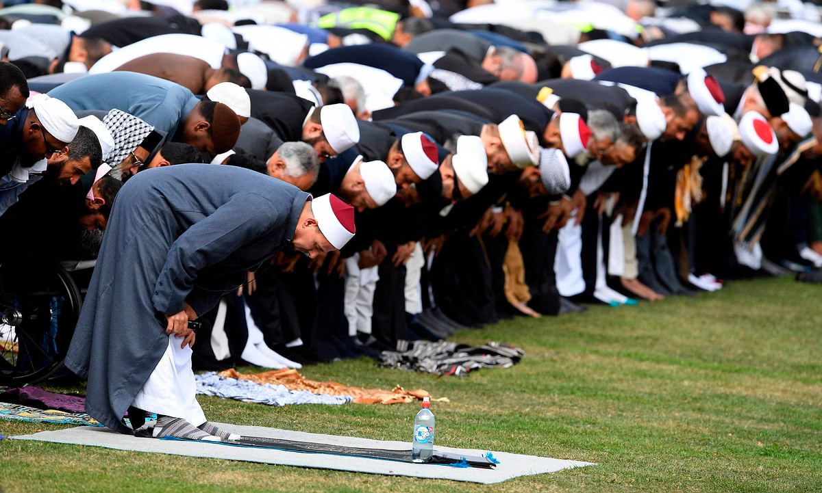 People pray during congregational Friday prayers and two minutes of silence for victims of the twin mosque massacre, at Hagley Park in Christchurch on 22 March 2109. Photo: AFP