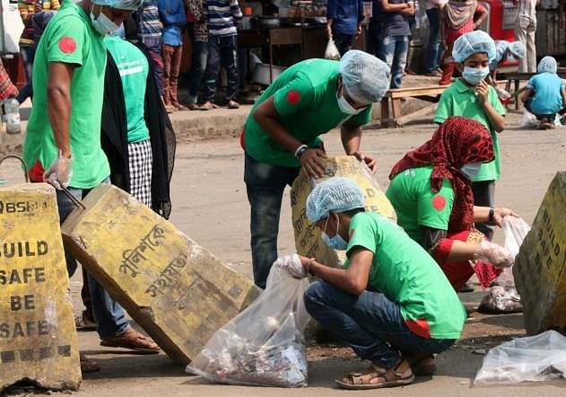 Members of voluntary organisation BD Clean cleans Shatmatha area of Bogura city on Friday, 22 March, 2019. Photo: Soel Rana