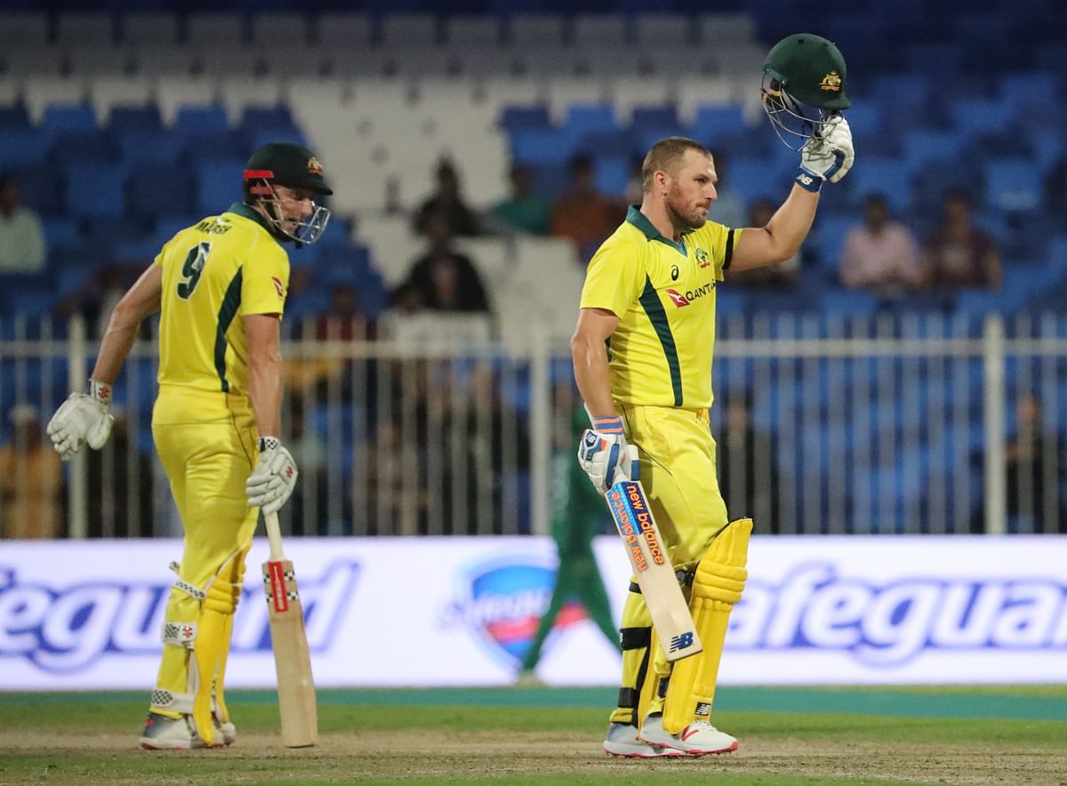 Australia`s Aaron Finch (R) celebrates his century (100 runs) during the first one-day international (ODI) cricket match between Pakistan and Australia at Sharjah Cricket Stadium in Sharjah on 22 March 2019. Photo: AFP