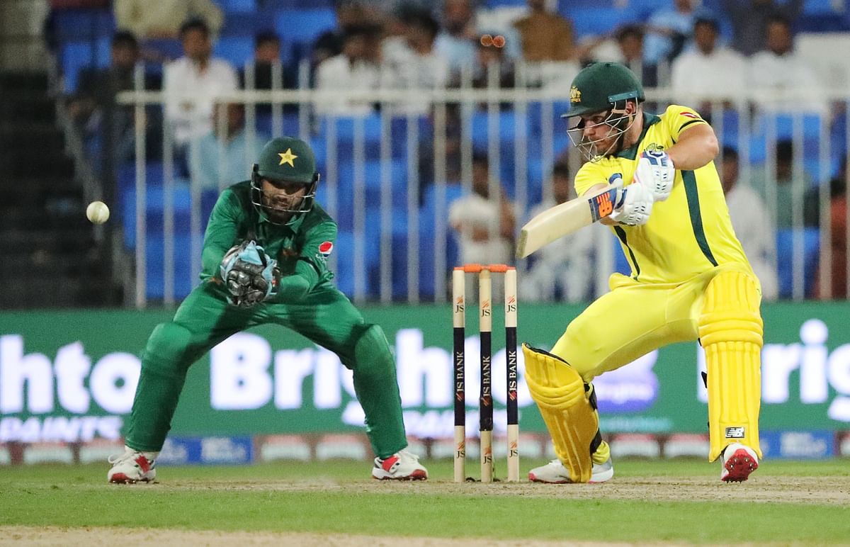 Australia`s Aaron Finch (R) plays a shot during the first one-day international (ODI) cricket match between Pakistan and Australia at Sharjah Cricket Stadium in Sharjah on 22 March 2019. Photo: AFP