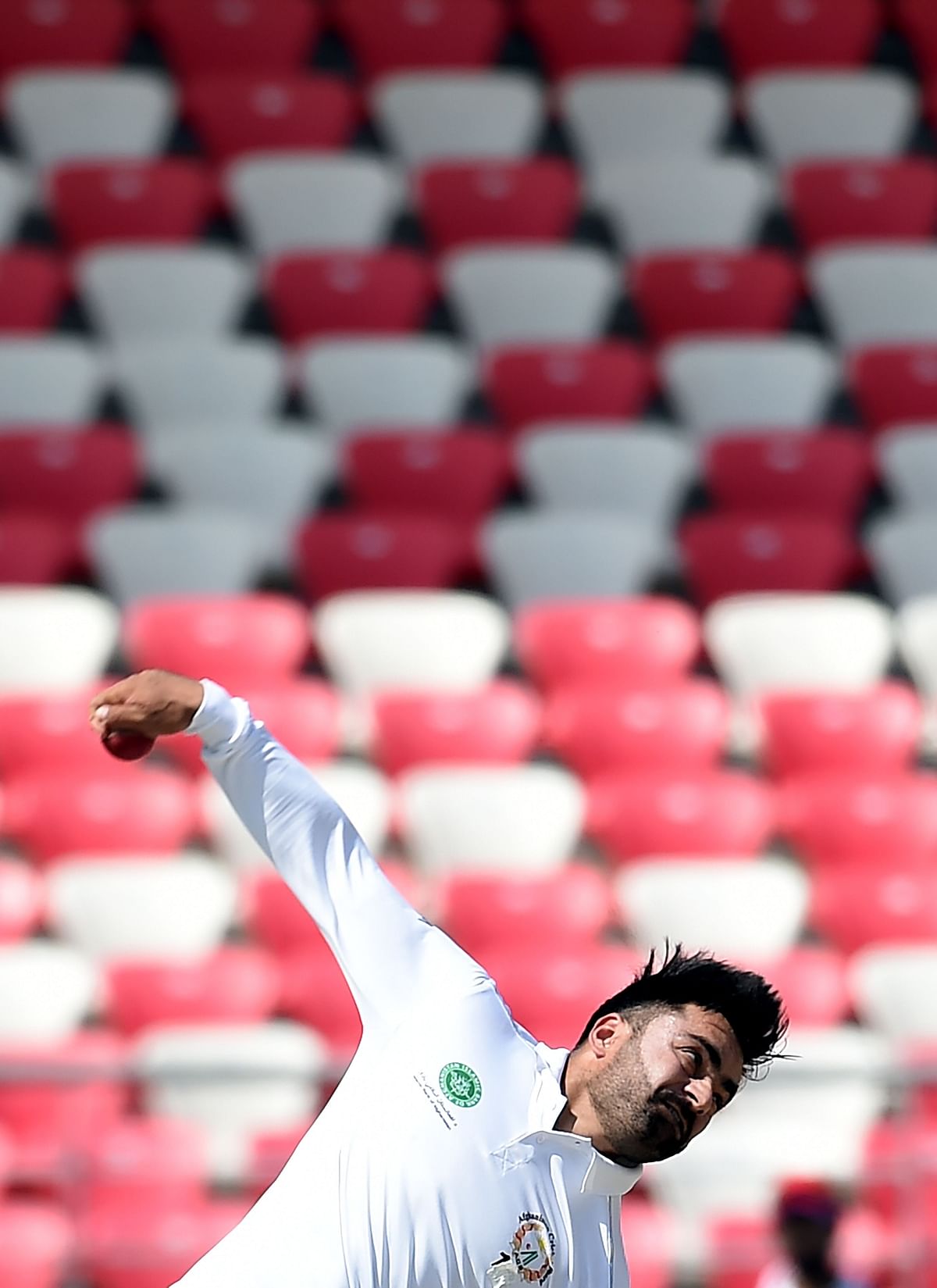 In this file photo taken on 17 March 2019, Afghanistan`s Rashid Khan bowls during the third day of the Test cricket match between Afghanistan and Ireland at the Rajiv Gandhi International Cricket Stadium in the northern Indian city of Dehradun. Photo: AFP