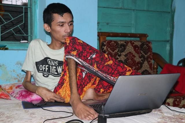 Fahimul working with his computer. Photo: Prothom Alo