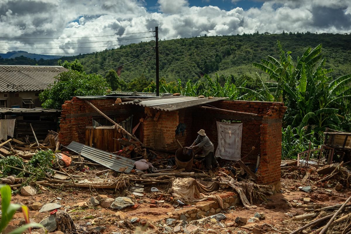 A man cleans up a destroyed house on 19 March 2019 in Chimanimani, as a hundred houses were damaged by the Cyclone Idai. More than a thousand people are feared to have died in Mozambique alone while scores have been killed and more than 200 are missing in neighbouring Zimbabwe following the deadliest cyclone to hit southern Africa. Photo: AFP