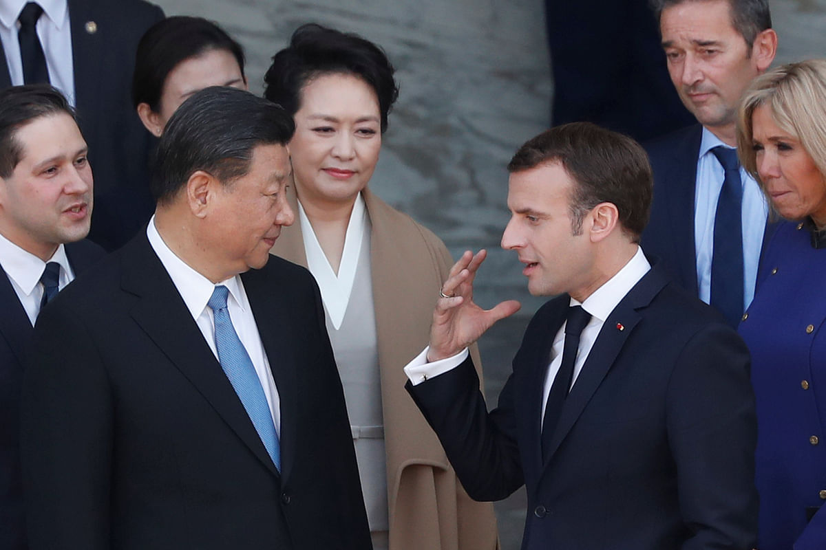 French president Emmanuel Macron talks with Chinese president Xi Jinping as Brigitte Macron and Peng Liyuan look on, at the Elysee presidential palace in Paris, France, 26 March 2019. Photo: Reuters