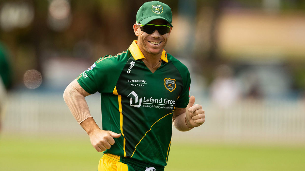 In this file photo taken on 22 September 2018 Randwick Petersham`s David Warner, and ex-Australian batsman, fields during a domestic cricket match between Randwick Petersham and St George at Coogee Oval in Coogee, a suburb in Sydney. Photo: AFP