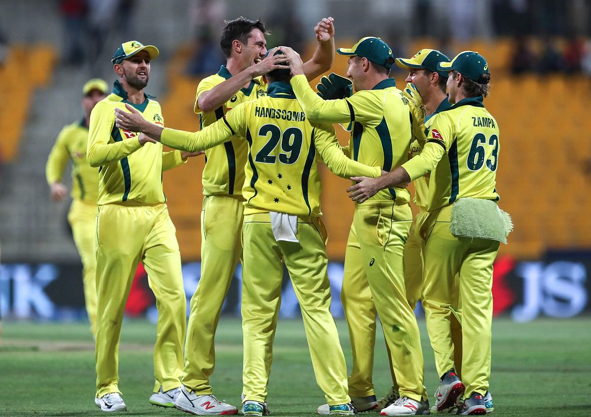 Australian cricketer Peter Handscomb (C) celebrates with his teammates catching Pakistan batsman Shan Masood off a ball from paceman Pat Cummins, during the third one day international (ODI) cricket match at Sheikh Zayed Stadium in Abu Dhabi on 27 March 2019. Photo: AFP
