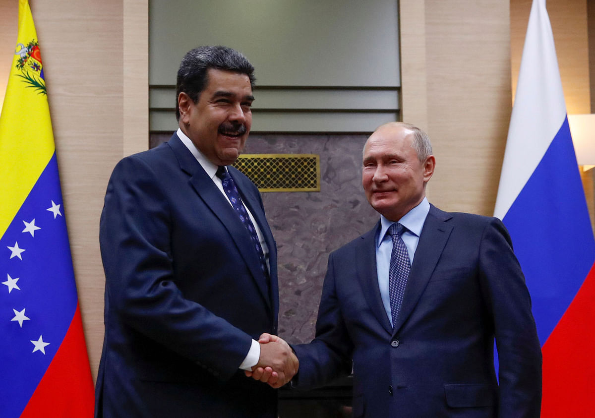 Russian president Vladimir Putin (R) shakes hands with his Venezuelan counterpart Nicolas Maduro during a meeting at the Novo-Ogaryovo state residence outside Moscow, Russia on 5 December 2018. Reuters File Photo