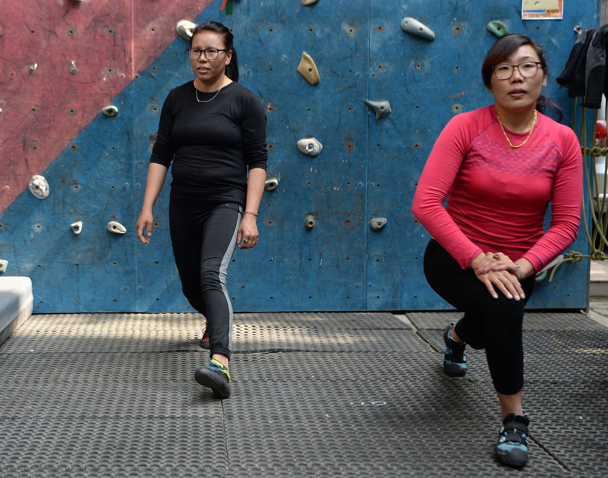 In this picture taken on 12 February 2019 Furdiki Sherpa (L) and Nima Doma Sherpa (R), the Nepali widows of mountaineers, train at a climbing gym in Kathmandu. Photo: AFP