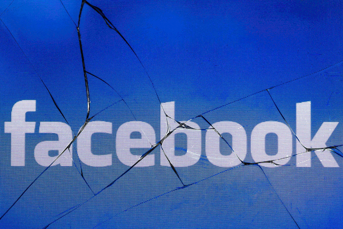 In this file photo taken in Paris on 16 May 2018 shows the logo of the social network Facebook on a broken screen of a mobile phone. Photo: AFP