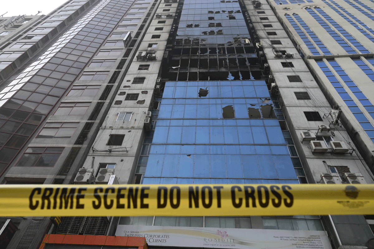 A crime scene ribbon surrounds the burnt building in Dhaka on 29 March 2019, a day after flames tore through the 22-storey FR Tower. Photo: AFP