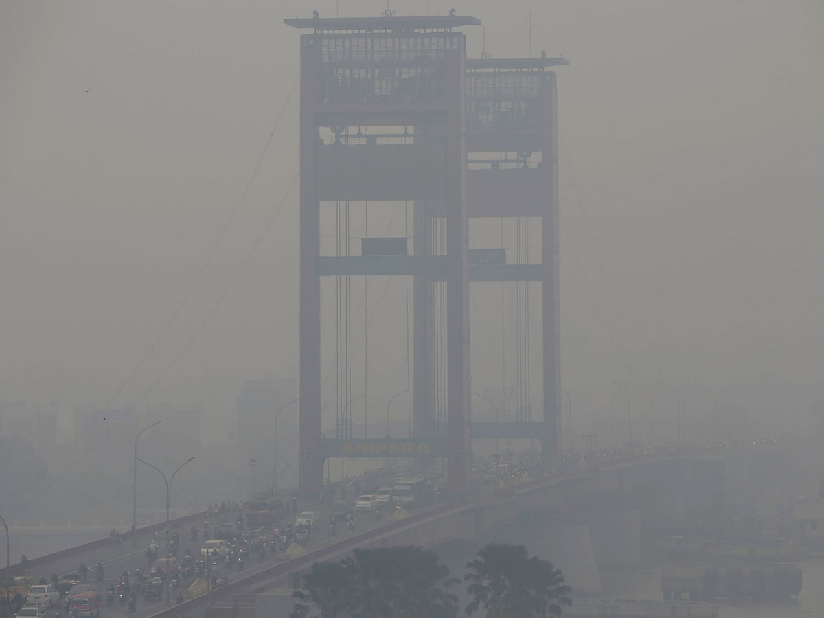 In this file photo, the vertical-lift Ampera Bridge spanning over the Musi River is shrouded by haze in Palembang, South Sumatra, Indonesia. AP File Photo