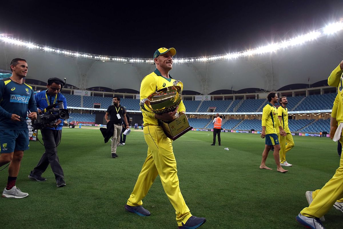 Australian cricketer Aaron Finch carries the trophy after his team won the fifth one day international (ODI) cricket match between Pakistan and Australia at Dubai International Stadium in Dubai on 31 March 2019. Photo: AFP