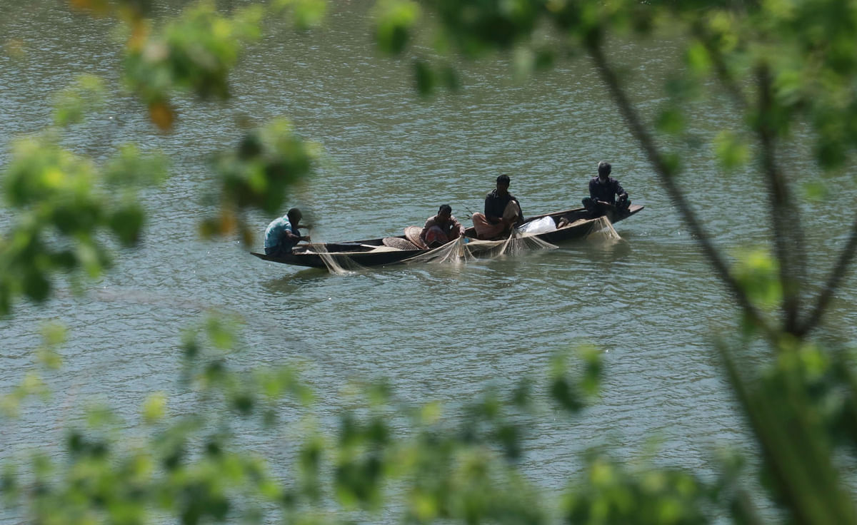 Men in boats fishing in the river Surma in Kushighat, Sylhet on 3 April 2019. Photo: Anis Mahmud
